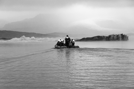 VATNAJOKULL, ICELAND - JULY 28, 201: Two families sailing on a Blue Ice Zodiac boat tour on the Fjallsarlon Glacial Lagoon on an arm of the huge Vatnajokull glacier in South Icelandのeditorial素材