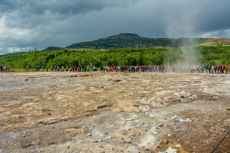 GOLDEN CIRCLE, ICELAND - AUG. 1, 2018: Tourists enjoying Geysir and Strokkur geysers and the surronding area at the Geysir geothermal Park on the Golden circle in Icelandのeditorial素材