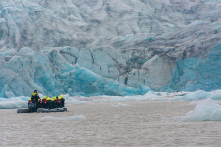 VATNAJOKULL, ICELAND - JULY 28, 201: Two families sailing on a Blue Ice Zodiac boat tour on the Fjallsarlon Glacial Lagoon on an arm of the huge Vatnajokull glacier in South Icelandのeditorial素材