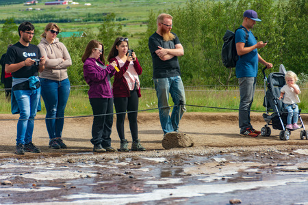 GOLDEN CIRCLE, ICELAND - AUG. 1, 2018: Tourists enjoying Geysir and Strokkur geysers and the surronding area at the Geysir geothermal Park on the Golden circle in Icelandのeditorial素材