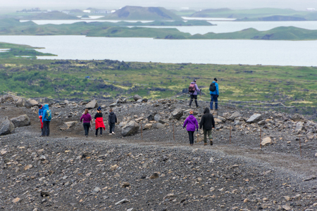 JULY 23, 2018 - KRAFLA, ICELAND: People hiking and climbing the Hverfjall - Hverfell volcano creater in Krafla, the volcanic area in Myvarn, Iceland.のeditorial素材