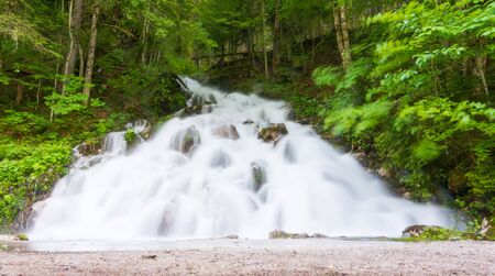 Waterfall on on Lake Gosau (Gosausee) in the Austrian Lake Districtの写真素材
