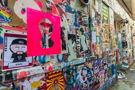 LONDON: August 25, 2019: Graffiti and posters at the poorer part of the hip Shoreditch quarter of Londonの写真素材