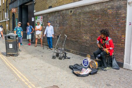 LONDON: August 25, 2019: People enjoying live street music in the hip Shoreditch quarterの写真素材