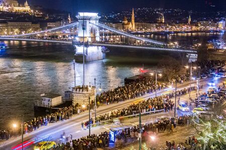 BUDAPEST - JAN. 1, 2020: Happy people celebrating the New Year and new decade on the Danube in Budapest with lots of fireworks at midnight.の写真素材