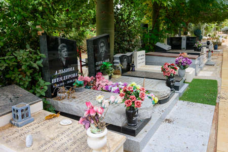 TEL AVIV - OCT. 26, 2019: Modern gravestones at  a secular civil and Jewish cemetery in Israel at the outskirts of Tel Aviv.  Hebrew and russian texts note the names and details of the deceased.のeditorial素材