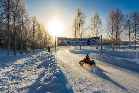 ROVANIEMI, FINLAND - FEB 26 2020: Tourists having a great time carting on snow and ice in Laplandのeditorial素材