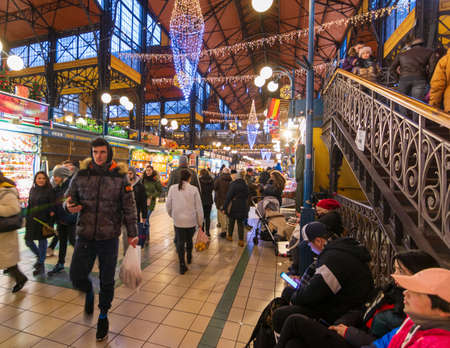 BUDAPEST - DEC. 30, 2019: People enjoying the colorful Great Market in Budapest all decorated and festive for Christmas on the eve of the new year and new decateのeditorial素材