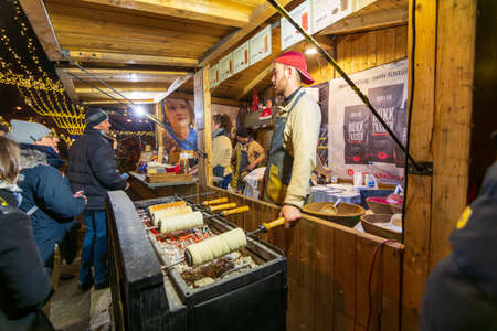 BUDAPEST - DEC. 29, 2019: Traditional preparation of hungarian kiortosh on charcoal at the Budapest Christmas Maekets on the eve of the new year and new decateのeditorial素材