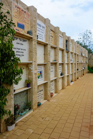 TEL AVIV - OCT. 26, 2019: Multi-level burial headstones at  a secular civil and Jewish cemetery in Israel at the outskirts of Tel Aviv.  Hebrew and russian texts note the names and details of the deceased.のeditorial素材
