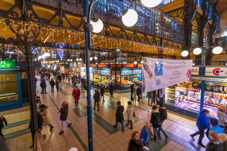 BUDAPEST - DEC. 30, 2019: People enjoying the colorful Great Market in Budapest all decorated and festive for Christmas on the eve of the new year and new decateのeditorial素材