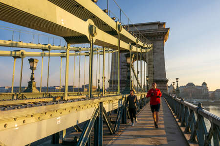 BUDAPEST - DEC. 30, 2019: SzÃ©chenyi Chain Bridge, Buda Castle, Parliament building and surrounding classical architecture of Budapest, Hungary at early morning golden hourのeditorial素材