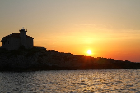 Sunset and lighthouseの写真素材