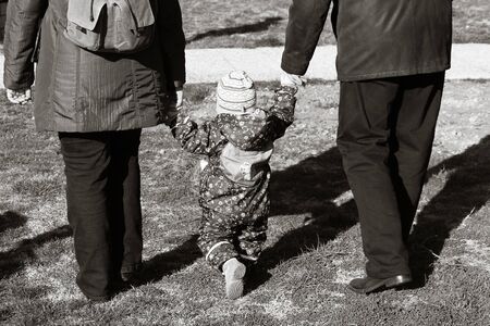 Granny and granpa walking their little angelの写真素材