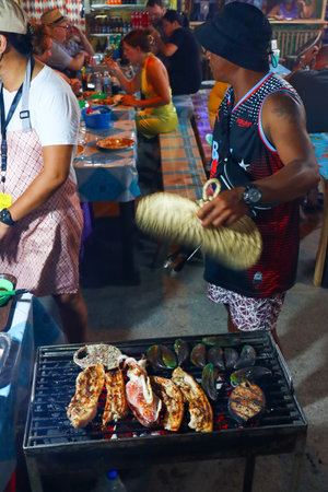Unidentified Thai people cook grilled meat on the street market.の写真素材