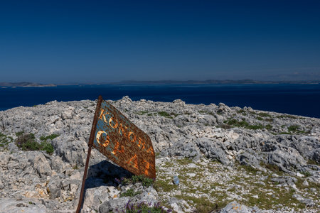 Signpost on the island of Rhodes, Greece with the Aegean Sea in the backgroundの写真素材