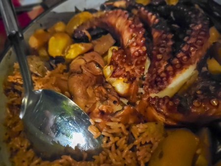 Seafood paella with octopus, squid, mussels and cornの写真素材