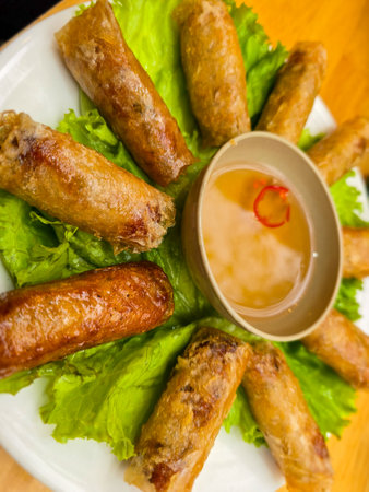 Fried spring rolls with dipping sauce on a plate, Thailand.