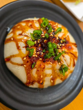 steamed dumpling with soy sauce and chilli on topの写真素材