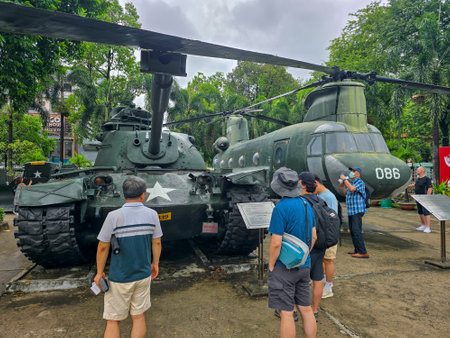 Unidentified tourists take pictures of the display of the military equipment at the museum.