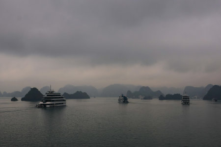 Cruise ships in Halong Bay, Vietnam in a rainy dayの写真素材