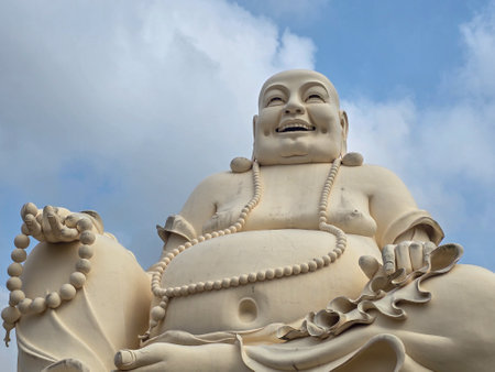 Buddha statue with blue sky and white cloud background in Thailandの写真素材
