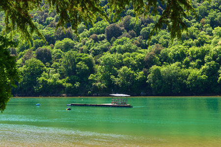 Lake in the mountains. Green trees and blue sky. Summer landscape.の写真素材