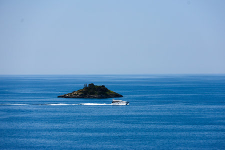 Island in the sea on a background of the blue sky.の写真素材