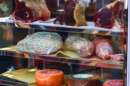 Meat products on display in a shop window in a butcher shop.