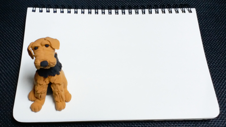 Blank note with a cute dog. Hand made clay dog, Airedale Terrier.の写真素材