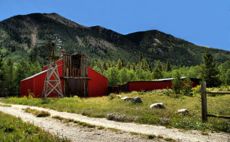 Barn and windmill in the Colorado Rocky Mountainsの写真素材