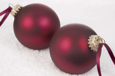 Two Christmas Ornament on a Snow backgroundの写真素材