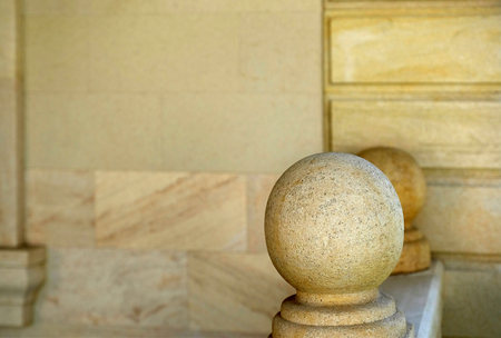 Stone ball on the railing against the wall. Decor.の写真素材