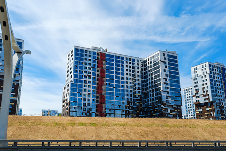 Modern residential building. Modern multi-storey building with glass facadeの写真素材