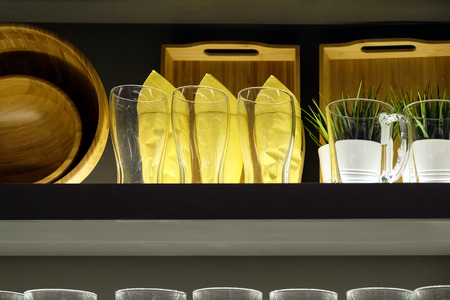 Dishes cups plates on a stand. Bottom light.の写真素材