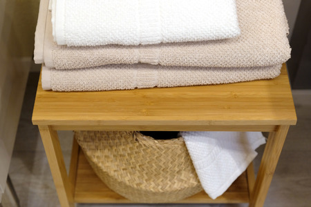 Clean colored towels hanging on the hanger in the bathroom. Towels are hung on hooks.の写真素材