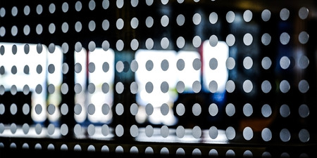 Abstract black background with frosted circles on the glass on the background of the street