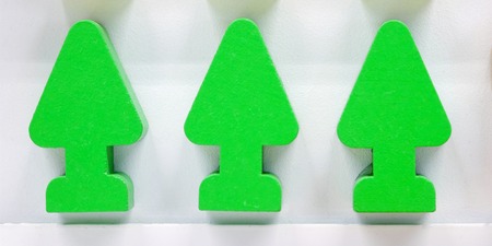 Small toy parts made of wooden blocks with drawings. In the form of trees and road signs. Green and yellow.の写真素材