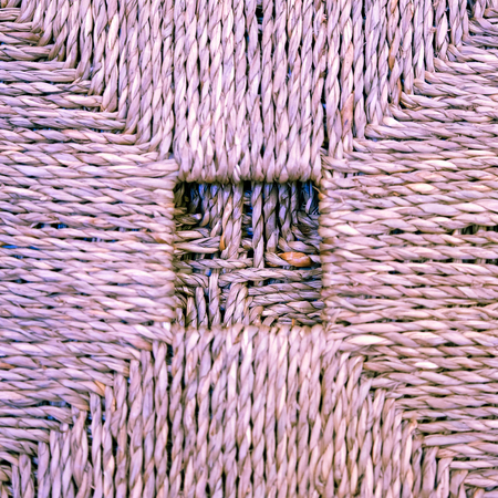 A woven Mat of reeds. The texture of dry cane. Light yellow.