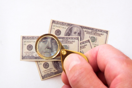 Souvenir hundred-dollar bills. Through the lens of a magnifying glass.の写真素材