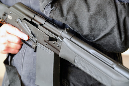 A soldier carrying a weapon in his hands with the safety off