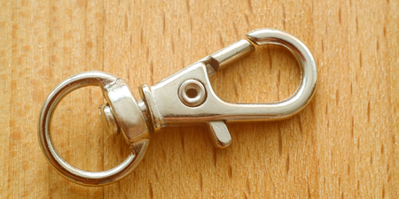 Carabiner for keys. Keychain with ring on wooden surface
