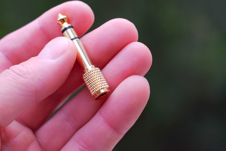 Adapter for audio. The adapter between the fingersの写真素材