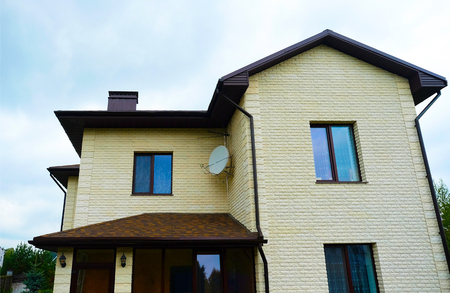 Cottage with panoramic large Windows. Glazing of the facade of the house. Tinted glass.の写真素材