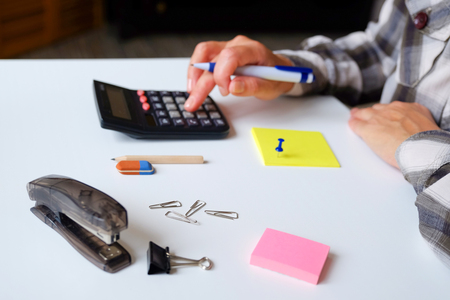 On the table, business items, pen and pencil with an elastic band. Paper clips buttons and other office.の写真素材