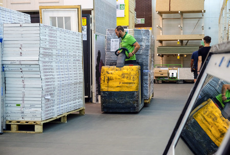 Saint-Petersburg. RUSSIA. 10.092018 Working on the loader carries construction materialsのeditorial素材