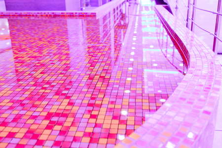 water in the pool with red-orange decorative tiles.の写真素材