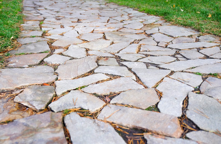 Ancient granite paving. Close-up view from above. Pavement