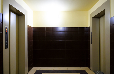 The Elevator corridor in the building is illuminated with white light. Elevator shaft in a...