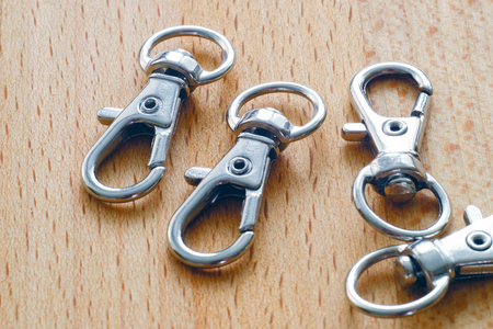 Carabiner for keys. Keychain with ring on wooden surface